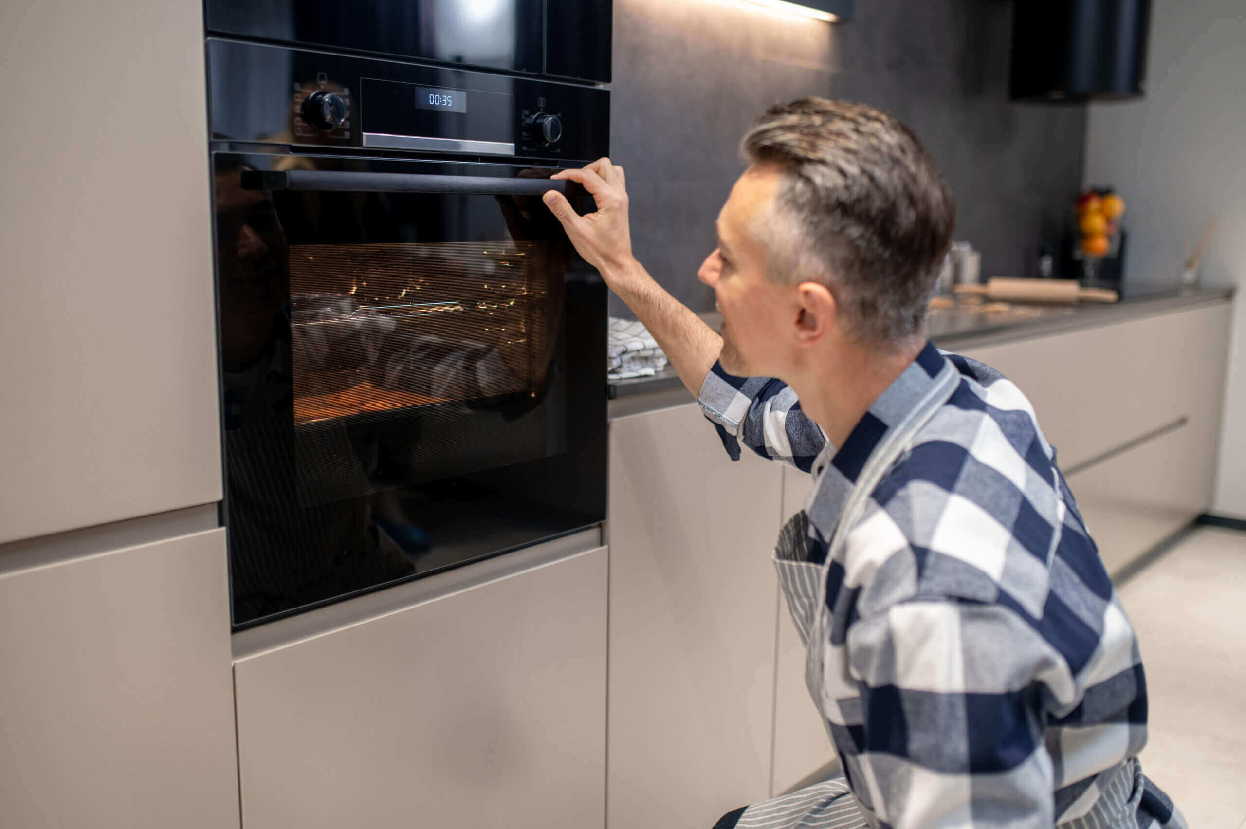 man fixing oven